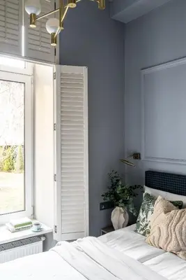 a living room with a gray couch and a bed at Moja apartments in Kraków