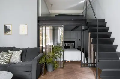 a bedroom with a bed and a table with a vase of flowers at Moja apartments in Kraków