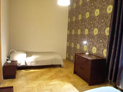 a bedroom with a bed and two nightstands and a bed sidx sidx sidx at Cracow Old Town Guest House in Kraków