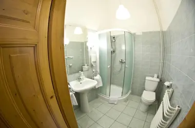 a bathroom with a sink and a toilet and a shower at Cracow Old Town Guest House in Kraków