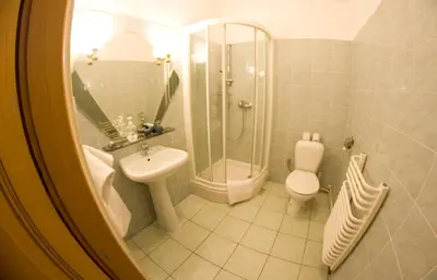 a bathroom with a sink and a shower and a toilet at Cracow Old Town Guest House in Kraków