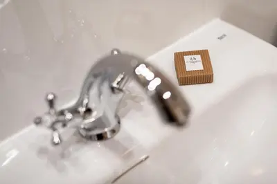 a bathroom sink with a faucet and a toothbrush at Lu Apartments in Oświęcim
