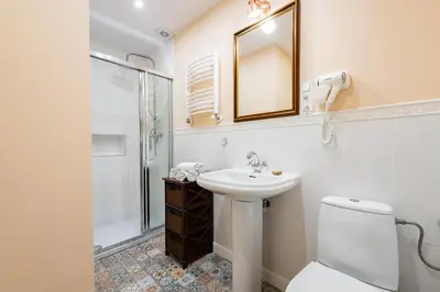 a bathroom with a sink and a toilet and a mirror at Lu Apartments in Oświęcim