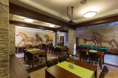 a restaurant with tables and chairs and a pool table at Hotel Górski Raj in Koninki