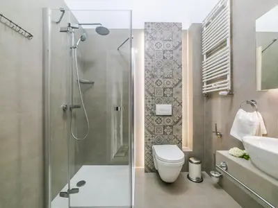 a bathroom with a shower and a toilet and a sink at Apartamenty Wrona | Wrona Apartments in Kraków