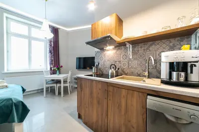 a kitchen with a sink and a counter top at Apartamenty Wrona | Wrona Apartments in Kraków