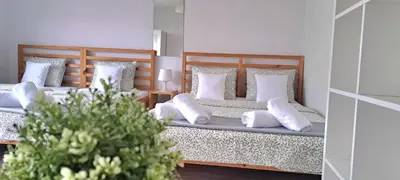 a bedroom with two beds with white pillows at Pokoje i Apartamenty na Szkolnej in Zator
