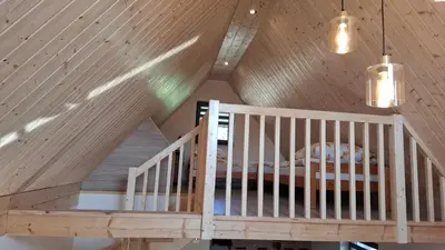 a room with a crib and a wooden ceiling at Agrorelax - Kasina Wielka in Kasina Wielka