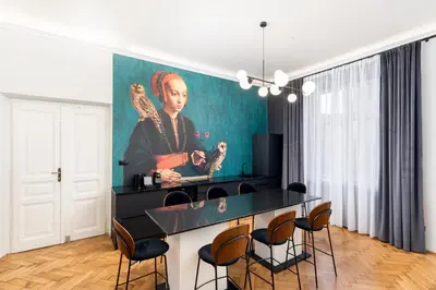 a living room with a painting of a man at Wawel Boutique Residence - Krakow Old Town in Kraków