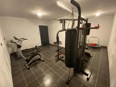 a gym with two treadmills and two exercise bikes at Holiday home Limanowa in Limanowa
