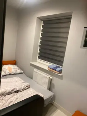 a small room with a bed and a window at Holiday home Limanowa in Limanowa
