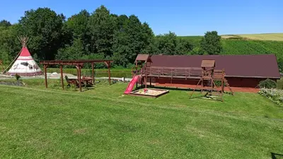 a park with a playground and a play structure at Leśny Zakątek Radocza in Radocza