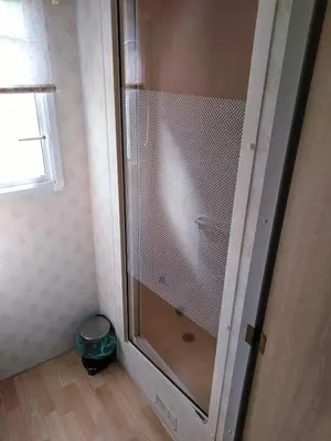 a shower with a glass door in a bathroom at Leśny Zakątek Radocza in Radocza