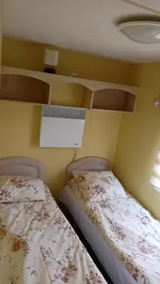 a bedroom with two beds and a window at Leśny Zakątek Radocza in Radocza