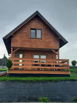 a large wooden house with a gambrel roof at Leśny Zakątek Radocza in Radocza