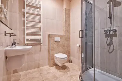 a bathroom with a toilet and a sink and a shower at Polin House in Oświęcim