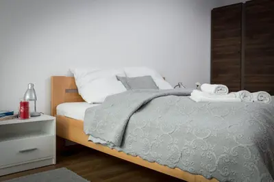 a bedroom with a bed with towels on it at Wawrzyńca Apartment with parking in Kraków