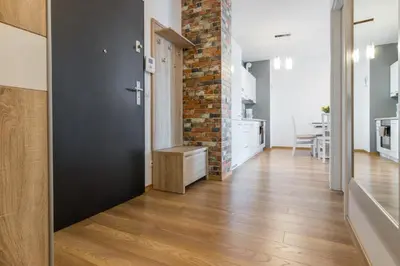 a kitchen and dining room with a brick wall at Wawrzyńca Apartment with parking in Kraków
