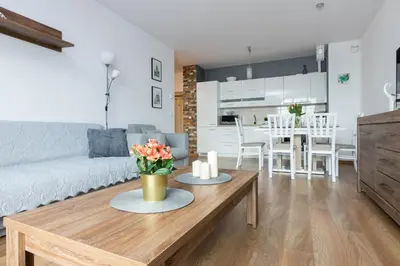 a living room with a couch and a table at Wawrzyńca Apartment with parking in Kraków