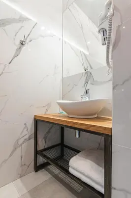 a bathroom with a sink on a wooden table at STAYPOLSKA in Oświęcim
