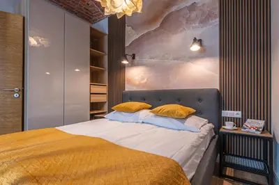 a bedroom with a bed with a painting on the wall at STAYPOLSKA in Oświęcim