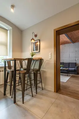 a dining room with a table and chairs and a mirror at STAYPOLSKA in Oświęcim