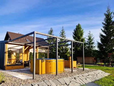 a small yellow house with a glass enclosure at Bulwary Mszańskie - Domki Całoroczne in Mszana Dolna