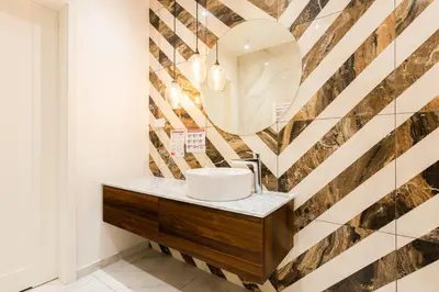 a bathroom with a sink and a mirror at Apartment Old Town Halicka street by NEARTO in Kraków