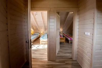 a room with two beds and a room with an open door at Na Dworosku in Golczowice