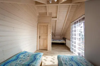 a small room with a bed and a door at Na Dworosku in Golczowice