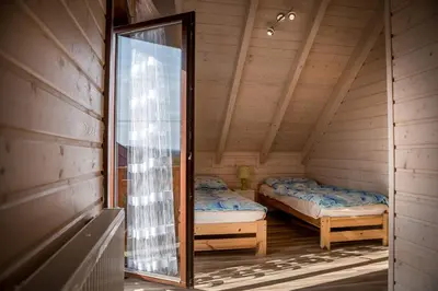 a mirror in the corner of a room with two beds at Na Dworosku in Golczowice