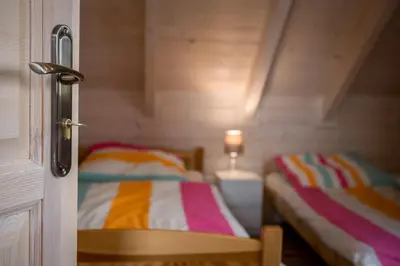 a room with two beds in a small room at Na Dworosku in Golczowice