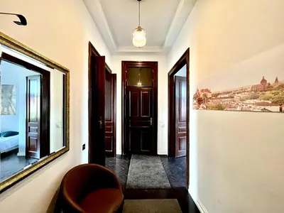 a mirror in a room with a bed at Apartamenty Długa 27 in Kraków