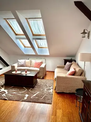 a bed with a white comforter in a bedroom at Apartamenty Długa 27 in Kraków