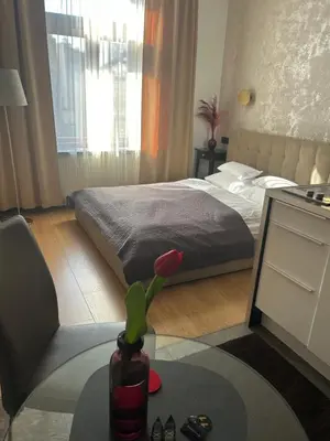 a kitchen and dining room with a table and chairs at Apartamenty Długa 27 in Kraków
