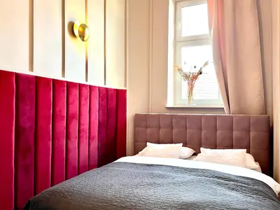 a bathroom with a tub with pink lights in it at Apartamenty Długa 27 in Kraków