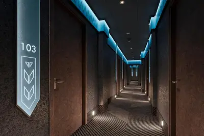a corridor of a building with blue lights at Avena Boutique Hotel by Artery Hotels in Kraków