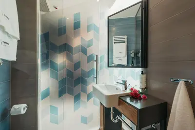 a bathroom with a sink and a mirror at Avena Boutique Hotel by Artery Hotels in Kraków