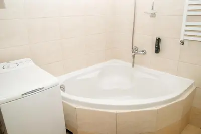 a large bed with two nightstands and two tables at Red Kurka Apartments in Kraków