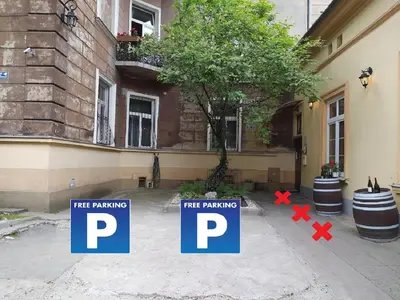 a bathroom with a toilet and potted plants on the wall at Red Kurka Apartments in Kraków