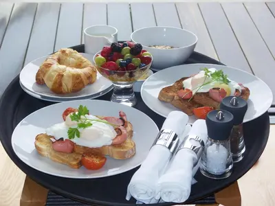 a table with three plates of breakfast foods on it at Miodowa Boutique Residence in Kraków
