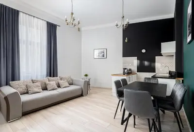 a living room with a couch and a table at Miodowa Boutique Residence in Kraków