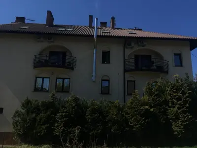 a building with two balconies on top of it at Pensjonat Przy Błoniach in Kraków