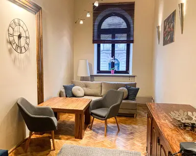 a living room with a couch and a table and chairs at Apartment Sare 11 in Kraków