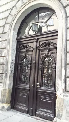 a pair of wooden doors on a building at Apartment Sare 11 in Kraków