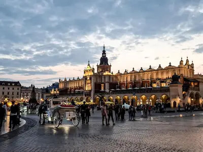 a horse drawn carriage in front of a large building at Apartment Sare 11 in Kraków