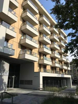 a building with balconies on the side of it at SHOQ STUDIO nice apartment with private parking in Kraków
