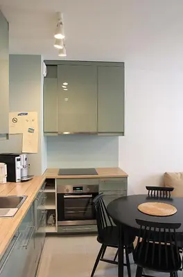 a kitchen with a table and a stove and cabinets at SHOQ STUDIO nice apartment with private parking in Kraków