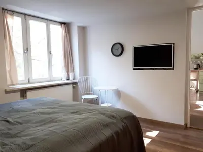 a bedroom with a bed and a tv on the wall at Bożego Ciała by Homeprime in Kraków