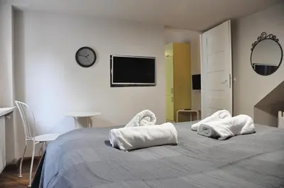 a bedroom with a bed with towels on it at Bożego Ciała by Homeprime in Kraków
